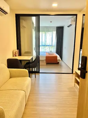 a living room with a couch and a bedroom at Dcondo Reef Serenity Condo 2 in Phuket Town