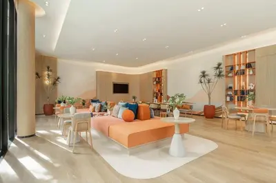 a living room with a couch and tables and chairs at Dcondo Reef Serenity Condo 2 in Phuket Town