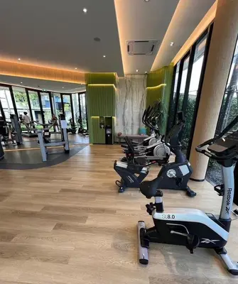 a gym with treadmills and exercise bikes in a room at Dcondo Reef Serenity Condo 2 in Phuket Town