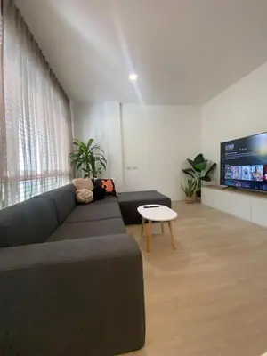 a living room with a couch and a table and a tv at Apartment in Rawai in Ban Saiyuan (1)