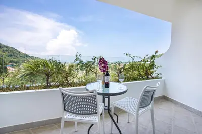 a table and chairs on a balcony with a view at Scenic Kata SeaView Condo O17-1BR just 5 min Drive to Kata Beach in Karon Beach