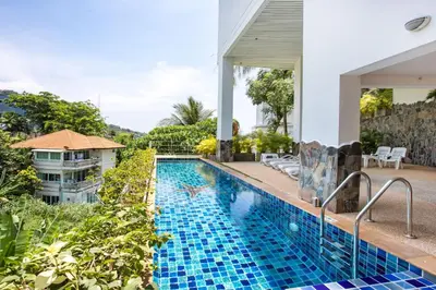 an outdoor swimming pool with blue tiles on the ground at Scenic Kata SeaView Condo O17-1BR just 5 min Drive to Kata Beach in Karon Beach