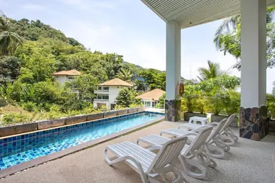 a view of a swimming pool with chaise lounge chairs at Scenic Kata SeaView Condo O17-1BR just 5 min Drive to Kata Beach in Karon Beach