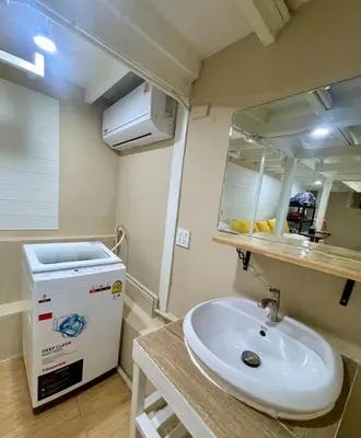 a bathroom with a sink and a large mirror at Baan Sangchai Beach in Ko Bon