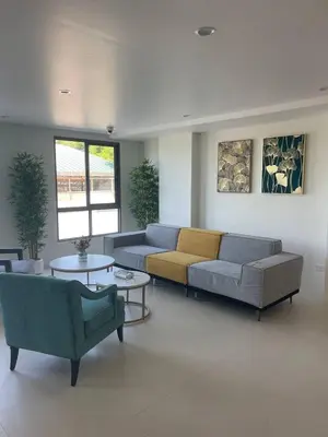 a living room with two couches and a table at Two-bedrooms apartments with kitchen in Phuket Town