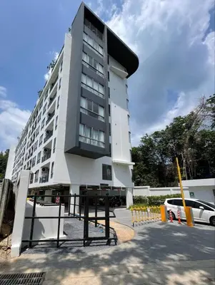 a tall white building with a lot of windows at Two-bedrooms apartments with kitchen in Phuket Town