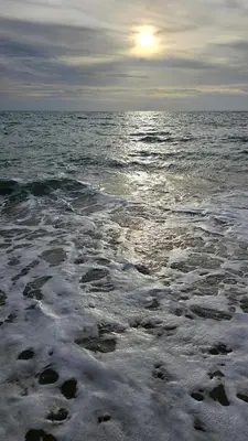 a beach with the sun rising over the ocean at New Apartment in 777 BEACH CONDO in Ban Mai Salae