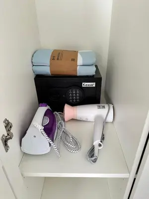 a hair dryer and a phone on a shelf at New Apartment in 777 BEACH CONDO in Ban Mai Salae