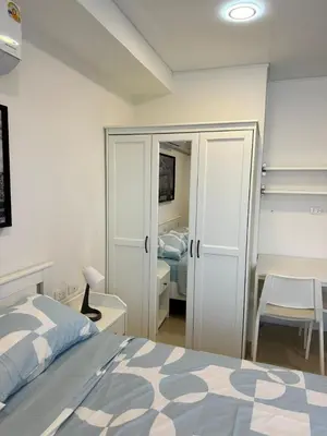 a bedroom with a bed and a desk with a bed at New apartment with mountain view in Ban Mai Salae