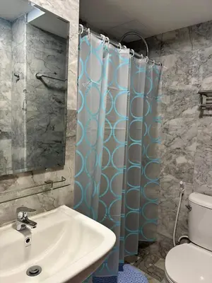 a bathroom with a sink and a toilet and a mirror at New apartment with mountain view in Ban Mai Salae