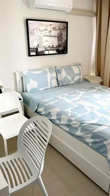 a bedroom with a bed and a chair in it at New apartment with mountain view in Ban Mai Salae