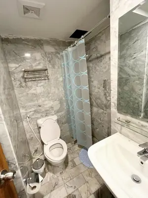a bathroom with a toilet and a sink at New apartment with mountain view in Ban Mai Salae