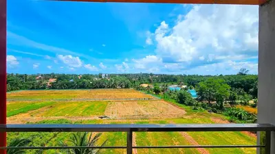 a view of a field from a balcony at Sunset view studio at 777 Beach Condo in Ban Mai Salae