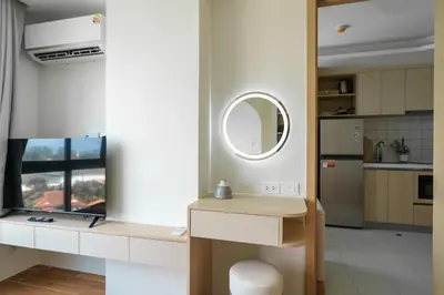 a kitchen with a table and a mirror on the wall at Kamala Beach View 1 BdR Roof Pool 500 mbps WiFi in Kamala Beach