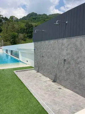 an external view of a building with a swimming pool at One-bedroom apartments with kitchen in Phuket Town