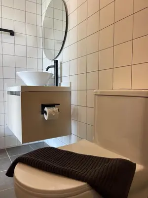 a bathroom with a sink and a toilet and a mirror at One-bedroom apartments with kitchen in Phuket Town