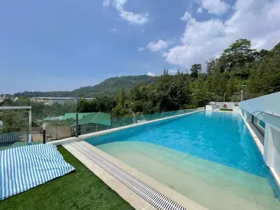 a large swimming pool with a view of a mountain at One-bedroom apartments with kitchen in Phuket Town