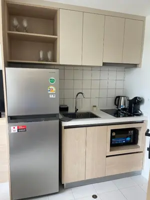 a kitchen with a refrigerator and a sink at One-bedroom apartments with kitchen in Phuket Town
