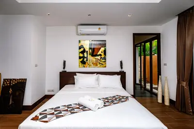 a bedroom with a large bed with white sheets at Villa SALSA PRIVATE POOL in Ko Yao Noi