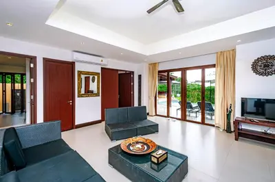 a living room with a couch and a tv at Villa SALSA PRIVATE POOL in Ko Yao Noi