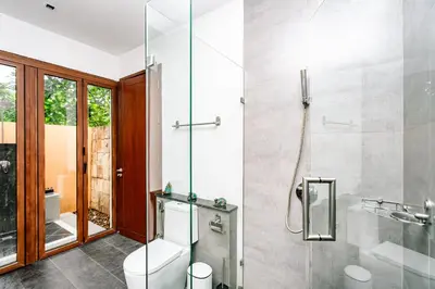 a bathroom with a toilet and a glass shower at Villa SALSA PRIVATE POOL in Ko Yao Noi