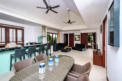 a dining room and living room with a table and chairs at Villa SALSA PRIVATE POOL in Ko Yao Noi