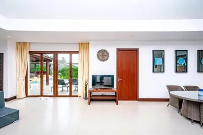 a living room with a television and a table at Villa SALSA PRIVATE POOL in Ko Yao Noi
