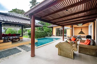 an outdoor patio with a pool and a wooden pergola at Villa SALSA PRIVATE POOL in Ko Yao Noi