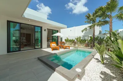 a villa with a swimming pool and a house at Staylar Pool Villas - Bangtao in Ban Pak Lak