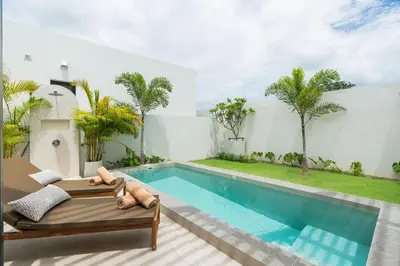 a villa with a swimming pool and a house at Staylar Pool Villas - Bangtao in Ban Pak Lak