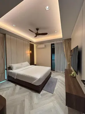 a bedroom with a bed and a ceiling fan at Mountain breeze villa phuket in Ban Bang Khu