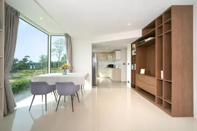 a kitchen and dining room with a table and chairs at Luxury Pool Access 2BR Patong in Patong Beach