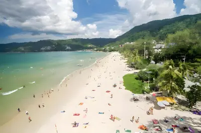 a group of people on a beach in the water at XX GO INN Patong Beach Phuket in Patong Beach