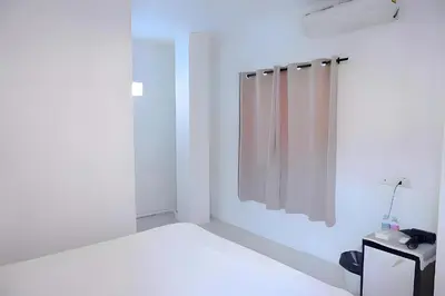 a white bathroom with a mirror and a sink at XX BAO Patong Beach Phuket - เบาป่าตองบีช in Patong Beach