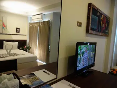a room with a desk with a computer and a mirror at Athome Hotel Nanai 8 in Patong Beach