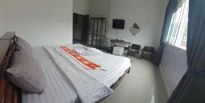 a hospital room with a bed with an orange blanket at Athome Hotel Nanai 8 in Patong Beach