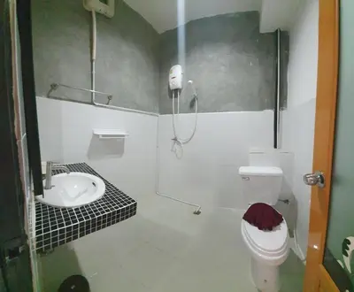 a bathroom with a shower and a toilet and a sink at Athome Hotel Nanai 8 in Patong Beach