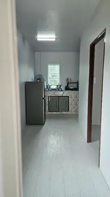 an empty kitchen with a refrigerator in a room at Cozy 1-Bedroom Bungalow with Shared Pool in Rawai in Nai Harn Beach