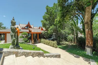 a statue of a man in front of a house at Villa Gecko with sea view pool, walk to Beach & Restaurants in Surin Beach