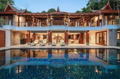 an exterior view of a house with a swimming pool at Villa Gecko with sea view pool, walk to Beach & Restaurants in Surin Beach
