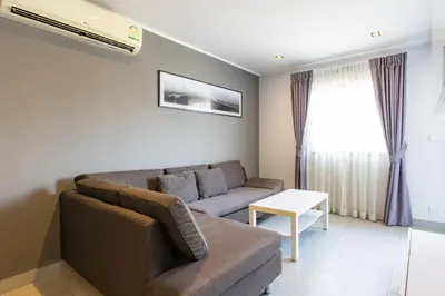 a living room with a couch and a table at Modern Condo - 1BR T1-201 in Ban Klang