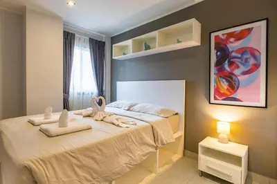 a bedroom with a bed with towels on it at Modern Condo - 1BR T1-201 in Ban Klang