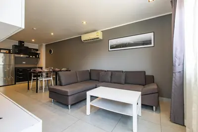 a living room with a couch and a table at Modern Condo - 1BR T1-201 in Ban Klang