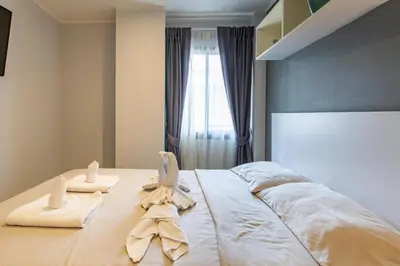 a bedroom with towels on a bed with a window at Modern Condo - 1BR T1-201 in Ban Klang