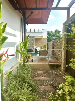 a patio with a table and chairs on a house at Pool Villa Private near Rawai Beach 2 bedrooms 3D9 in Rawai Beach