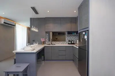a kitchen with a refrigerator and a counter top at Tropics Kamala 2BR Apartment CTG L602-3, Several Pools, Gym & Rooftop in Kamala Beach