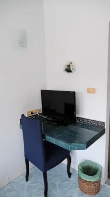 a blue desk with a computer on top of it at Karon Cove at Seabreeze Inn in Karon Beach
