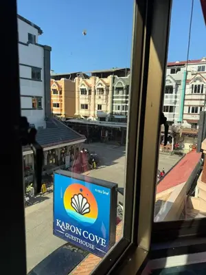 a view from a window of a kagon cove sign at Karon Cove at Seabreeze Inn in Karon Beach