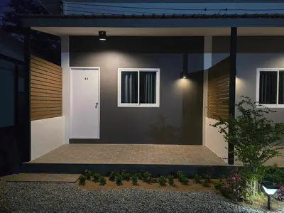 a house with a pathway leading to the front door at แวะพักสเตย์โฮสเทล Wae Phak Stay Hostel in Ban Huai Sai