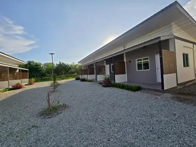 a building with a gravel driveway in front of it at แวะพักสเตย์โฮสเทล Wae Phak Stay Hostel in Ban Huai Sai